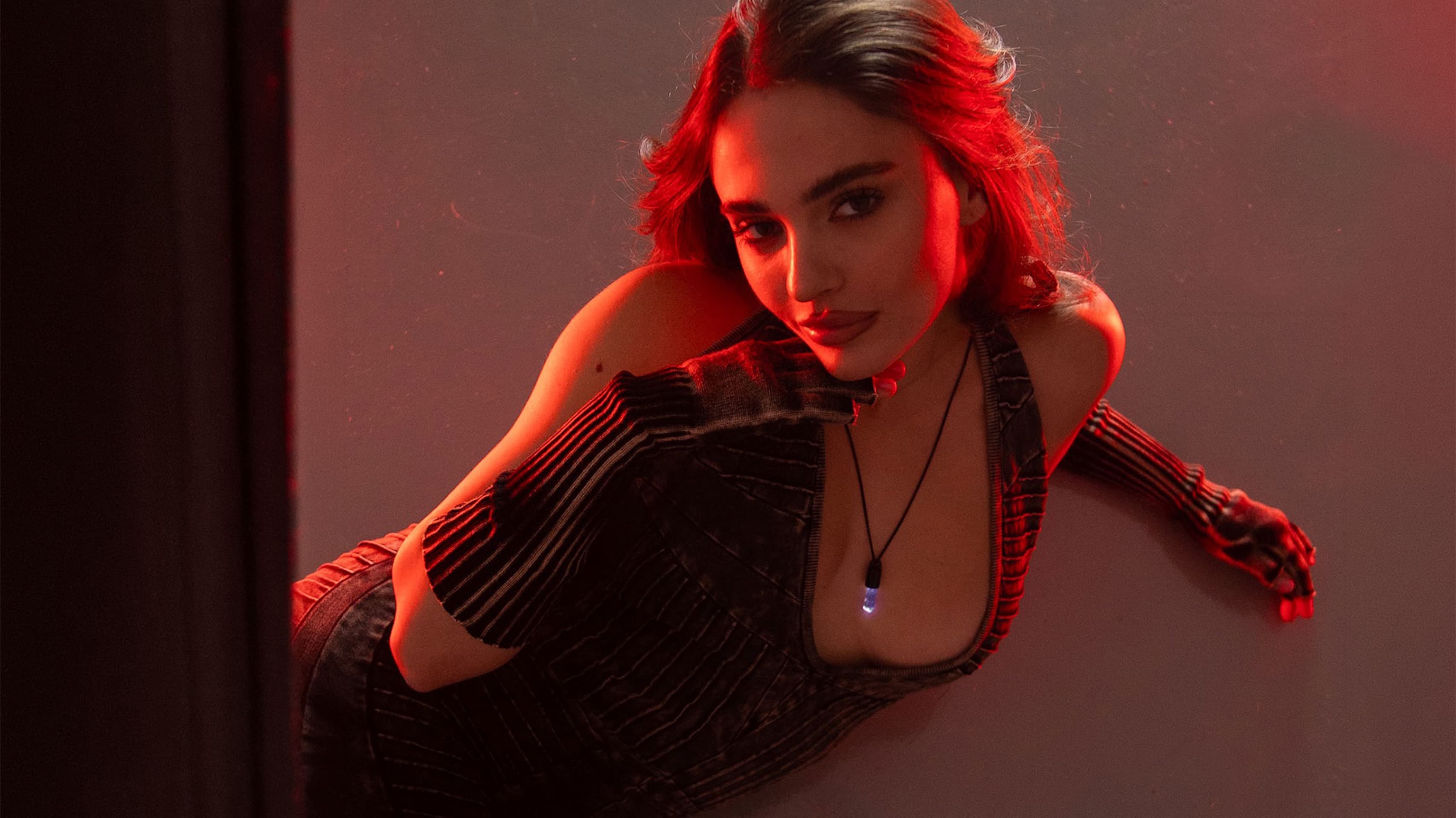 The Spire Pendant glowing in red studio light